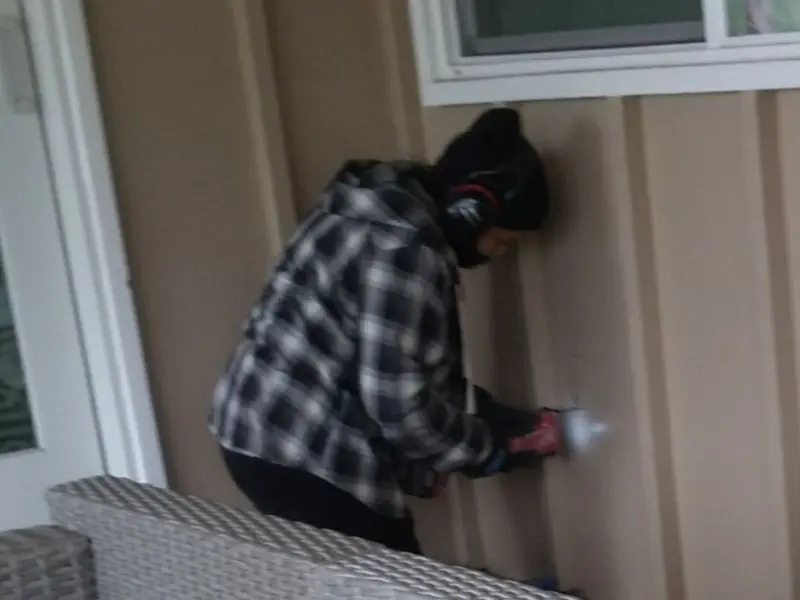 Professional electrician installing an exterior outlet in Mora